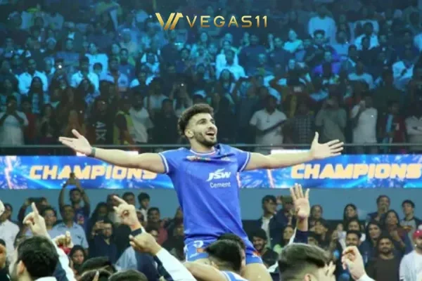 PKL Season 12 champion player celebrating victory with arms raised as teammates lift him up in packed stadium