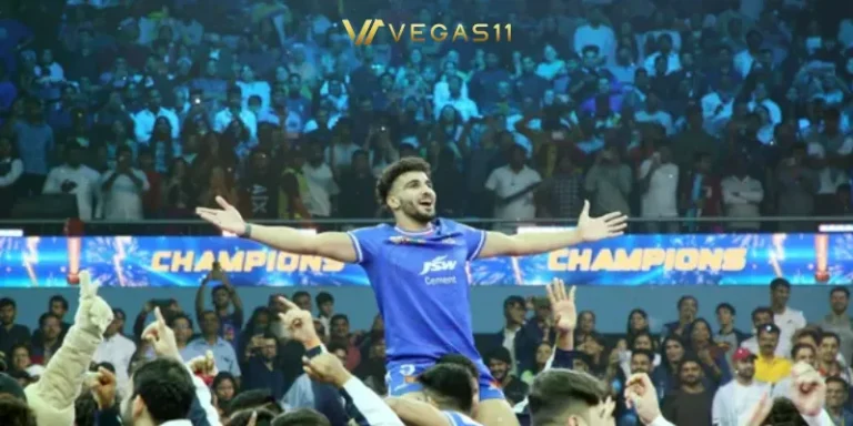 PKL Season 12 champion player celebrating victory with arms raised as teammates lift him up in packed stadium