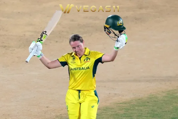 Australian captain Alyssa Healy raises her bat after scoring 142 runs in Women's Cricket World Cup match against India at Vizag