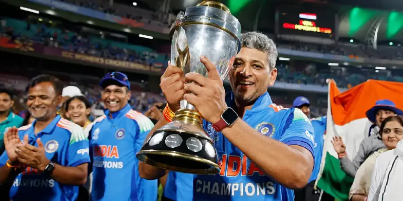 Indian women cricket team head coach Amol Muzumdar celebrating maiden ODI World Cup championship trophy 2025 with players at stadium