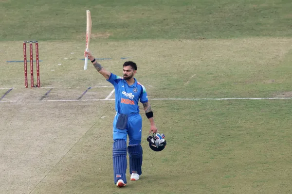 Virat Kohli century celebration India blue jersey bat raised JSCA Stadium Ranchi ODI South Africa November 2025