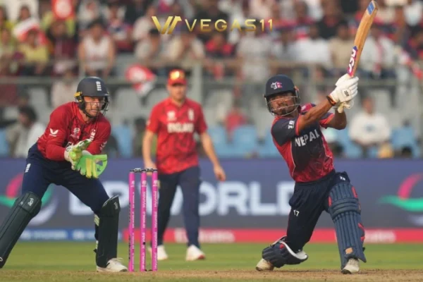 England cricket team celebrating T20 World Cup win against Nepal scorecard showing 184-7 vs 180-6