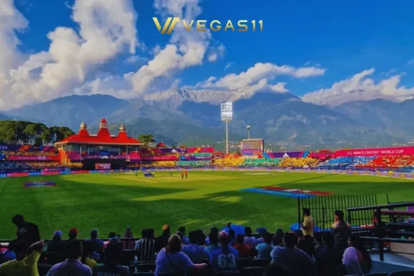 Dharamsala Cricket Stadium HPCA at night during IPL 2026 with snow-capped Dhauladhar mountains in the background