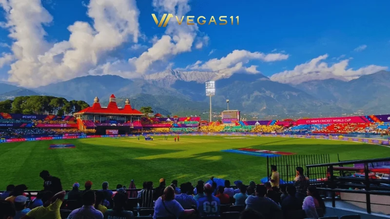 Dharamsala Cricket Stadium HPCA at night during IPL 2026 with snow-capped Dhauladhar mountains in the background